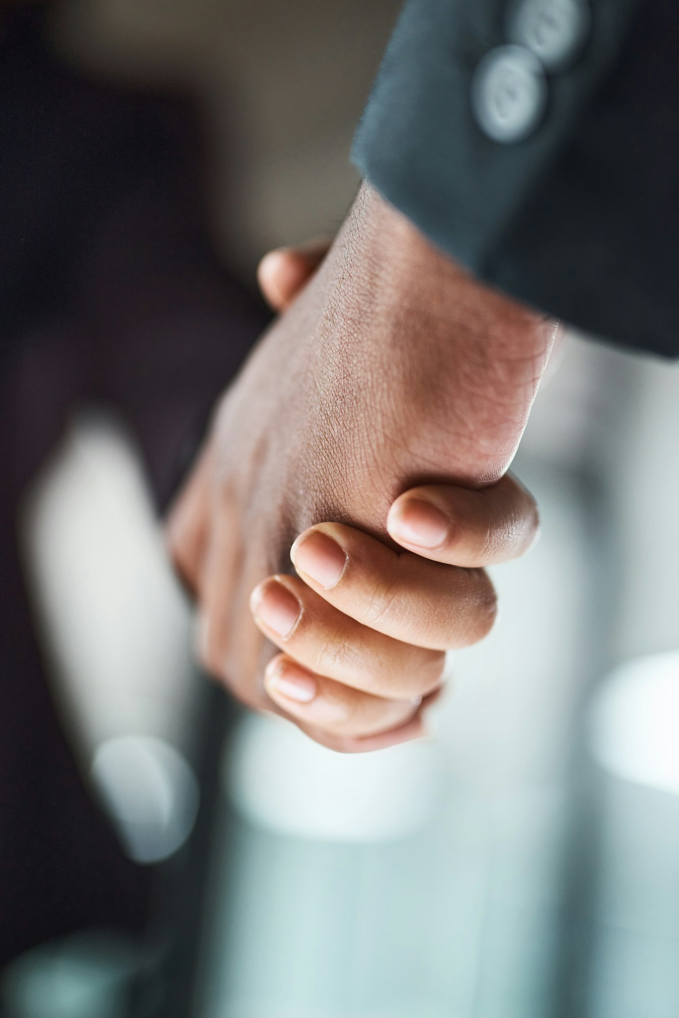 Cropped shot of two unrecognizable businesspeople shaking hands in an office